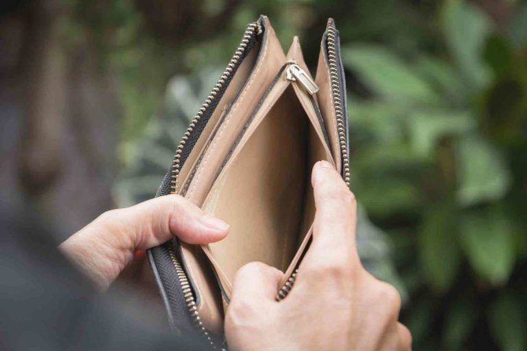 Hand öffnet leere Geldbörse